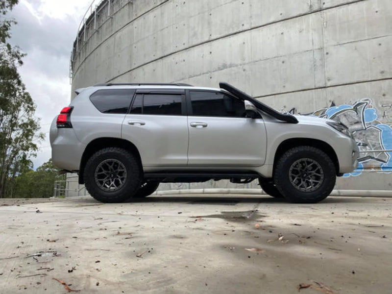 Silver Toyota Land Cruiser SUV with black wheels showcasing Meredith stainless steel snorkel kit