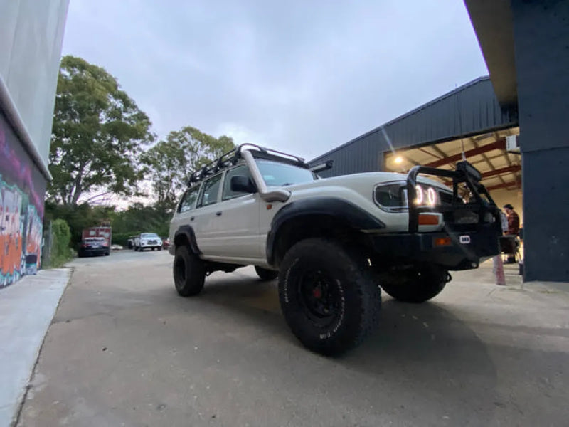 Modified Toyota Land Cruiser with stainless steel snorkel kit, lifted suspension, off-road tires