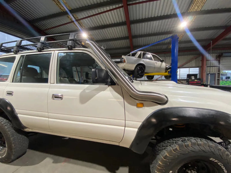 Stainless steel snorkel kit for Toyota 80 Series Landcruiser off-road vehicle with raised suspension