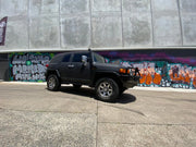 Black SUV with stainless steel snorkel parked in front of graffiti wall for Toyota FJ Cruiser