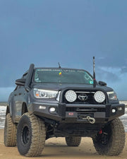 Modified Toyota Hilux pickup truck with stainless steel snorkel kit for off-road adventures