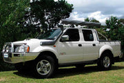 White Nissan Navara D22 pickup truck with off-road modifications and Safari Snorkel installed