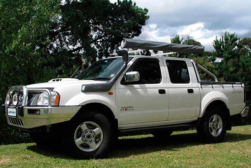 White Nissan Navara D22 pickup truck with off-road modifications and Safari Snorkel installed