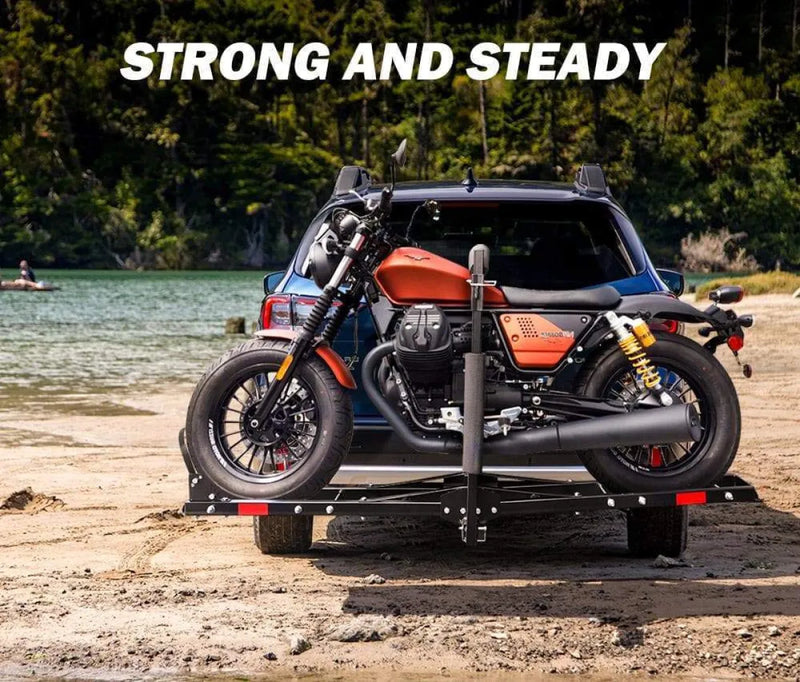 San Hima motorcycle carrier rack with ramp mounted on vehicle near lake shore