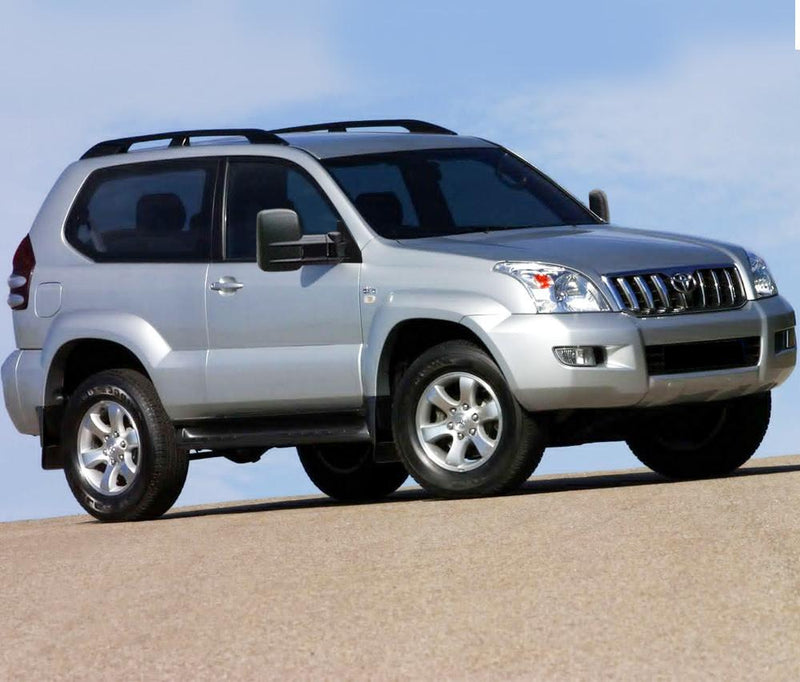 Silver Toyota Prado SUV with San Hima extendable towing mirrors on sandy surface