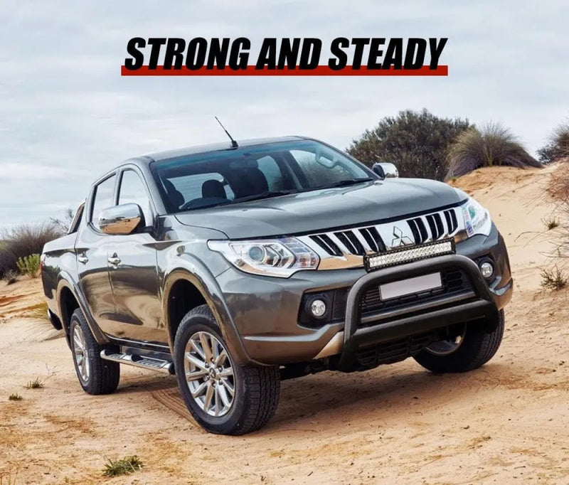 Silver Mitsubishi Triton nudge bar grille guard on sandy terrain for San Hima Nudge Bar