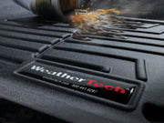 WeatherTech FloorLiner with water beading on textured surface, designed for vehicle protection