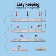Foldable camping table with collapsible metal poles and flat surface for portable camping use