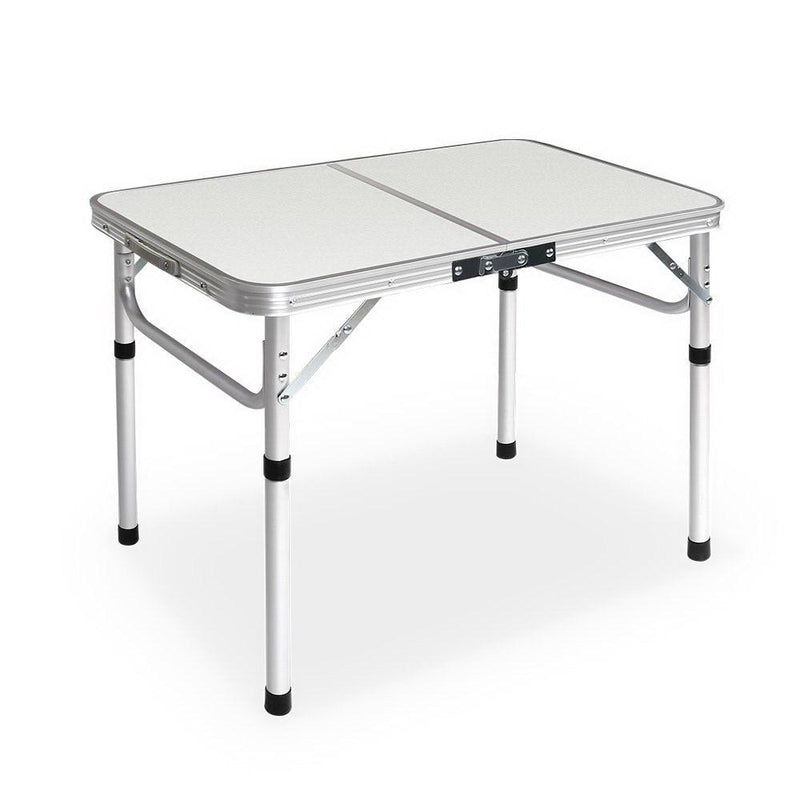 Portable folding camping table with adjustable aluminum legs and white top surface